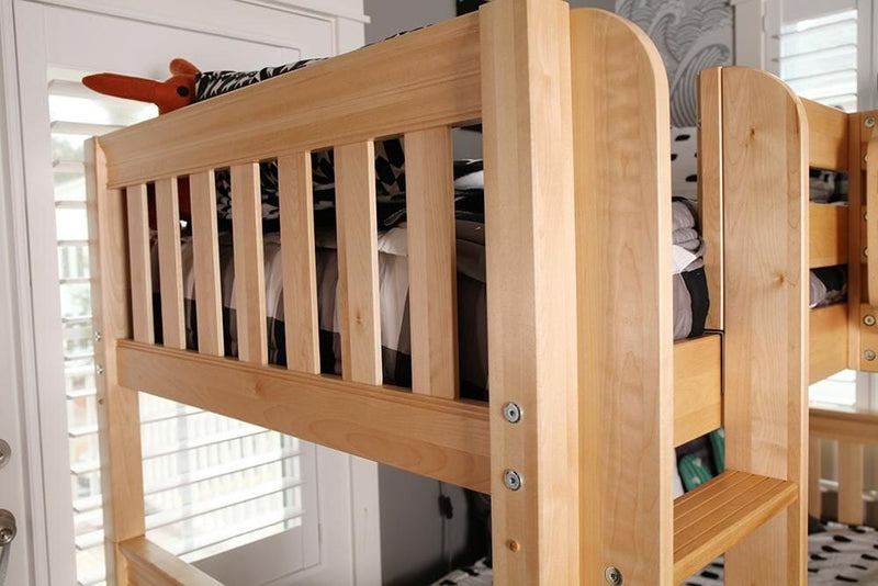 Natural maple twin-over-twin bunk bed with slatted safety rail and built-in ladder in a bright sunlit bedroom