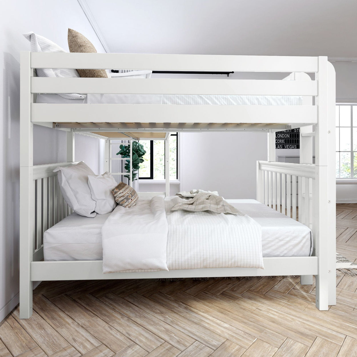 White wooden bunk bed in a bright, modern bedroom with wooden flooring and decorative plants.