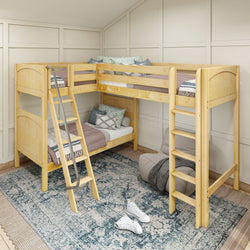 Wooden L-shaped bunk bed with ladders in cozy bedroom setting, featuring cushions and a patterned rug.