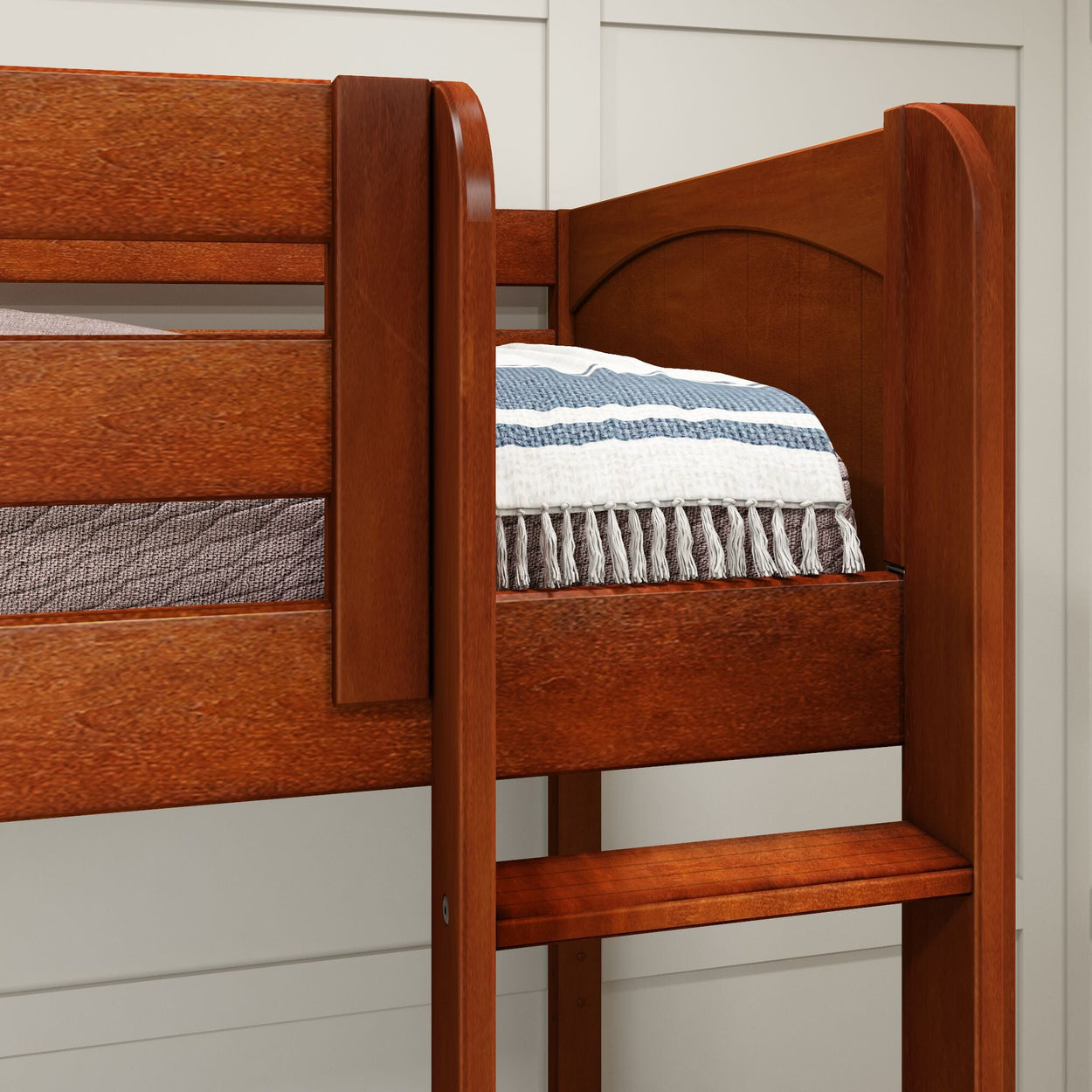 Rustic wooden bunk bed with striped blanket in cozy bedroom setting.