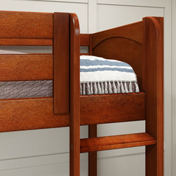 Rustic wooden bunk bed with striped blanket in cozy bedroom setting.