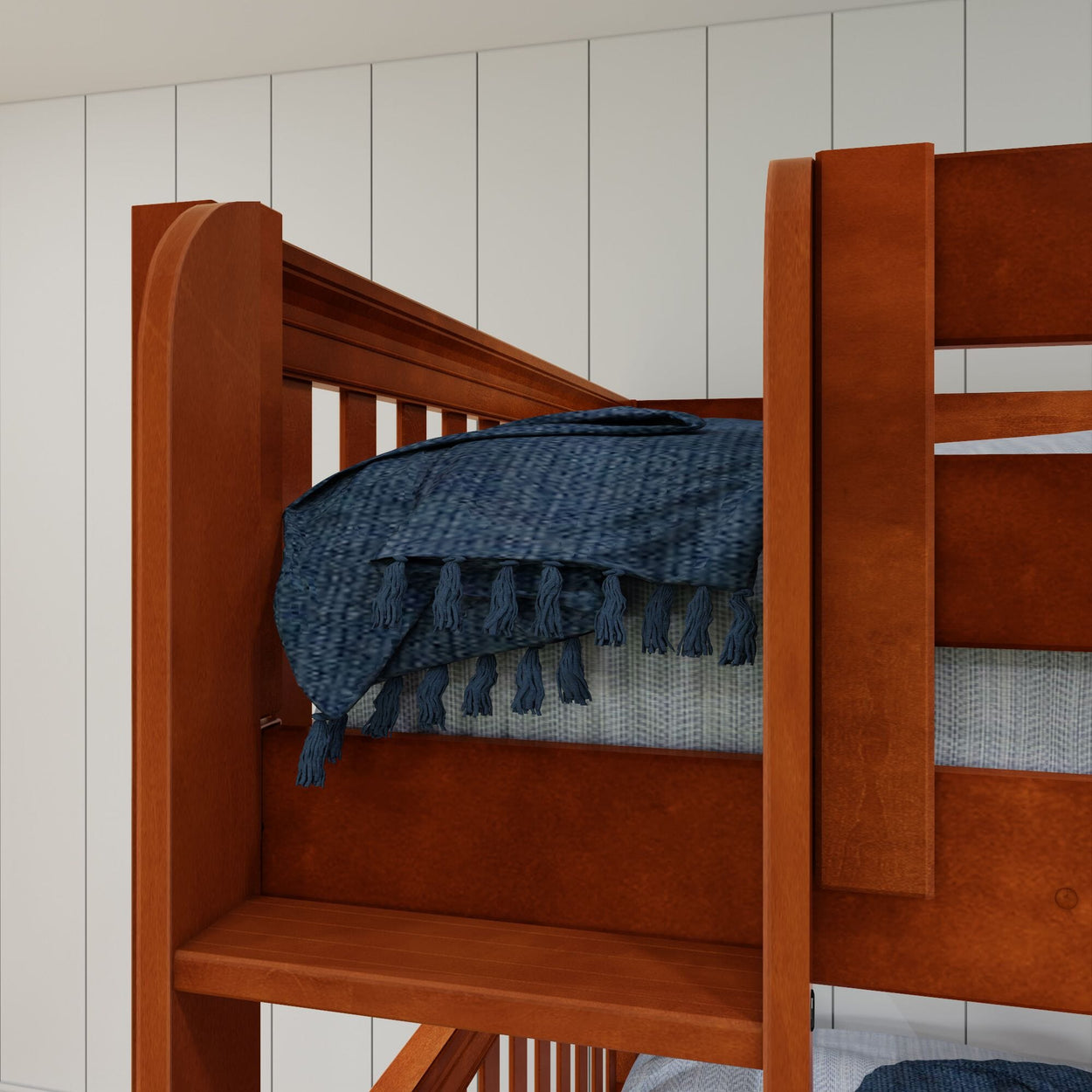 Wooden bunk bed with blue tassel blanket in modern bedroom setting.