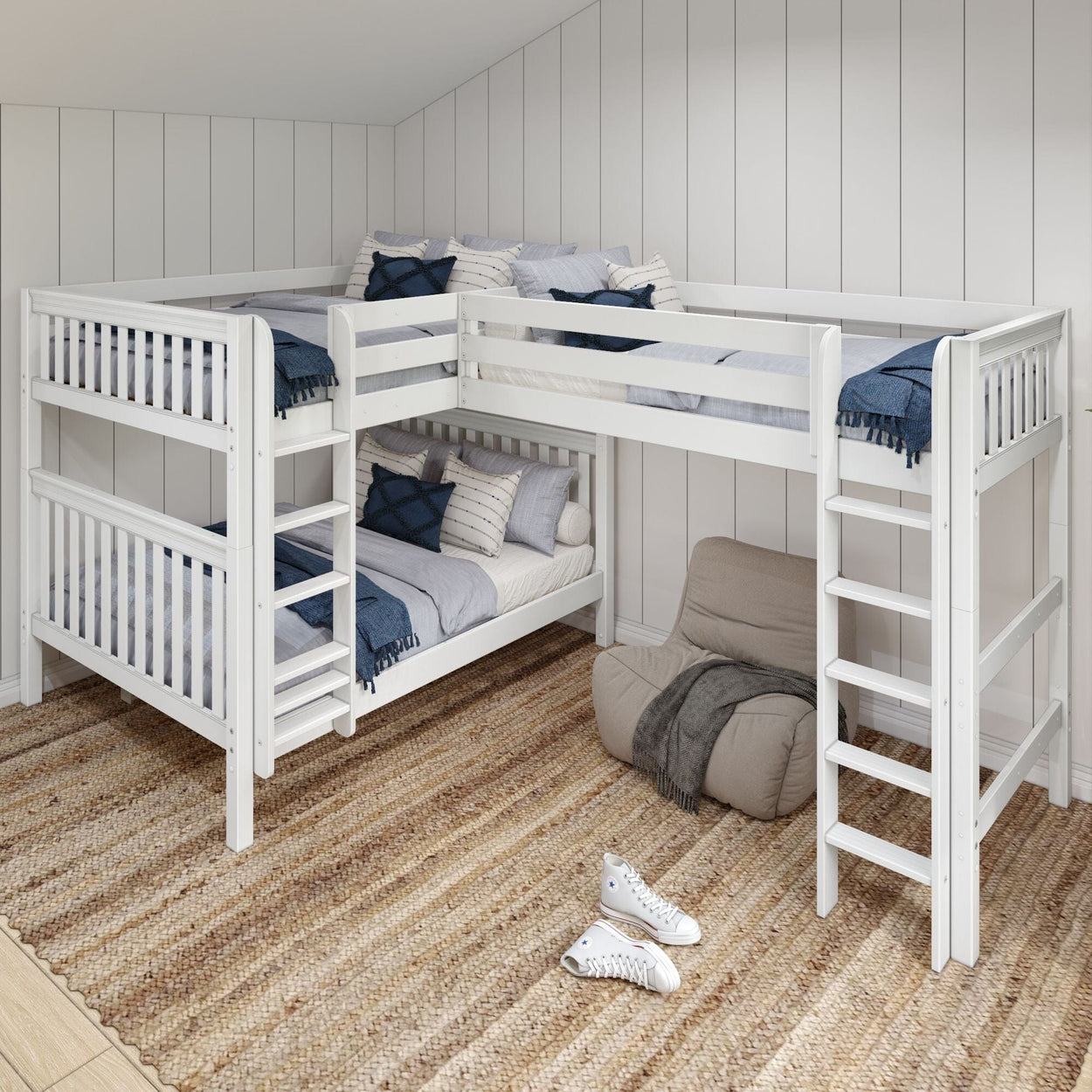 White triple bunk bed with ladders in a modern bedroom, featuring cozy bedding, a beige bean bag chair, and a woven rug, ideal for maximizing space.