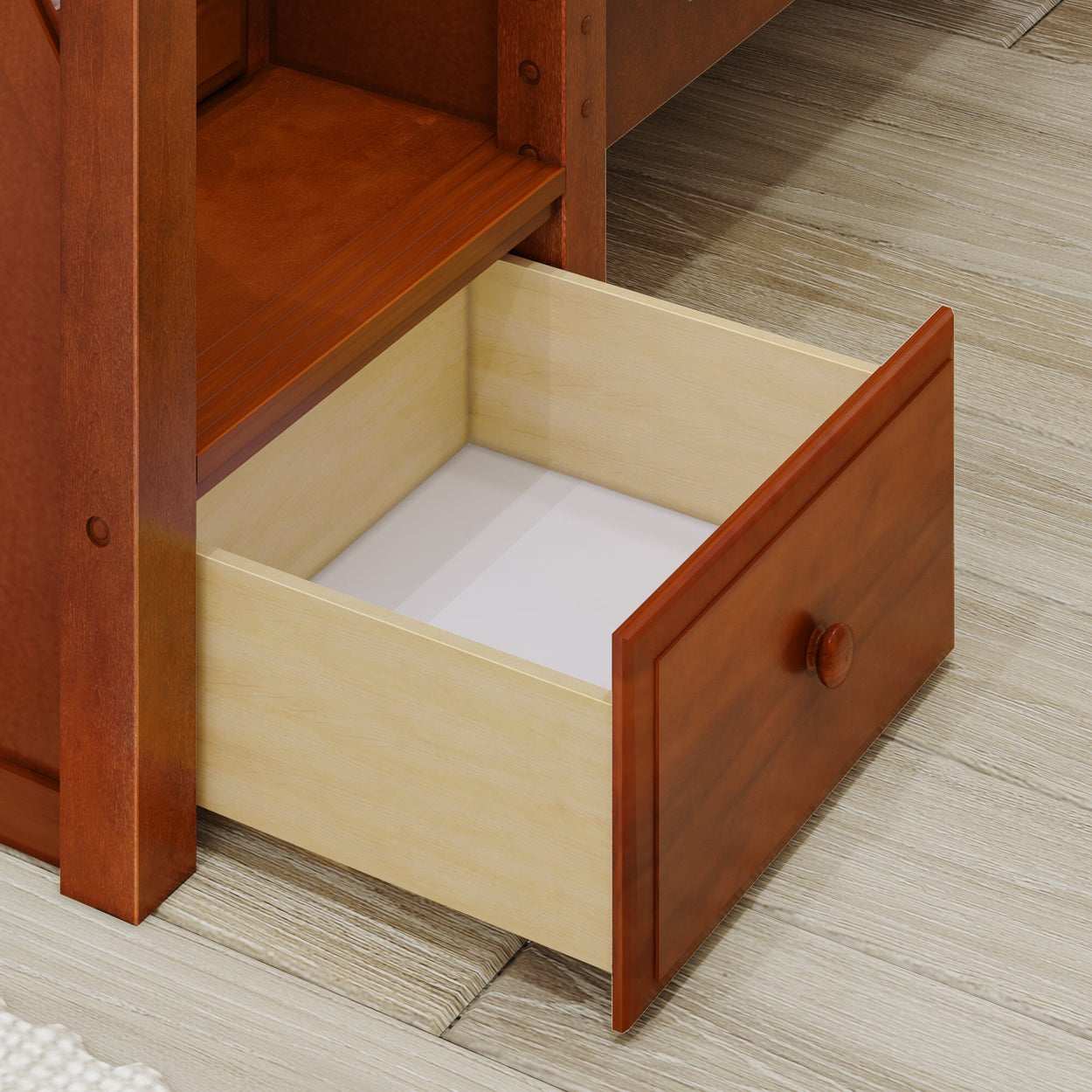 Open wooden drawer on a wooden floor, showcasing interior design and storage solutions.