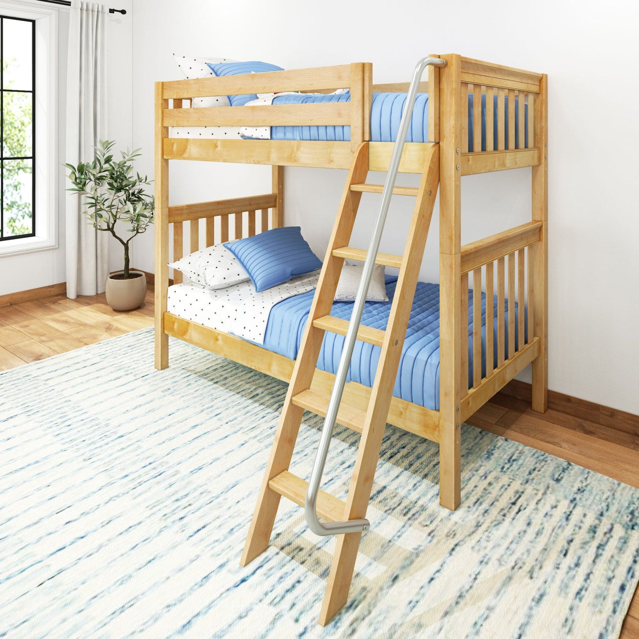 Wooden bunk bed with blue bedding and ladder in a bright bedroom with a rug.