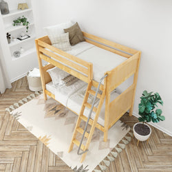 Wooden bunk bed with stairs in a modern bedroom featuring cozy bedding, decorative pillows, and a potted plant.