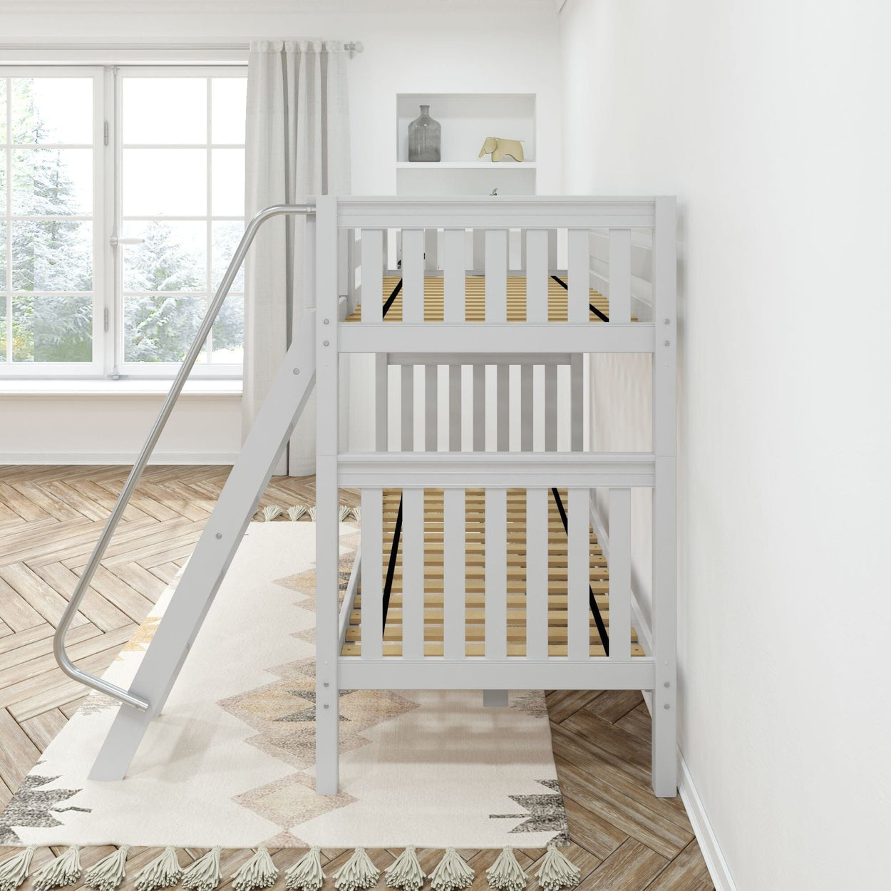 White metal ladder bunk bed in a bright, modern bedroom with large window and herringbone wood flooring.