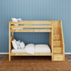 Wooden bunk bed with stairs in a modern bedroom featuring blue walls and cozy bedding.