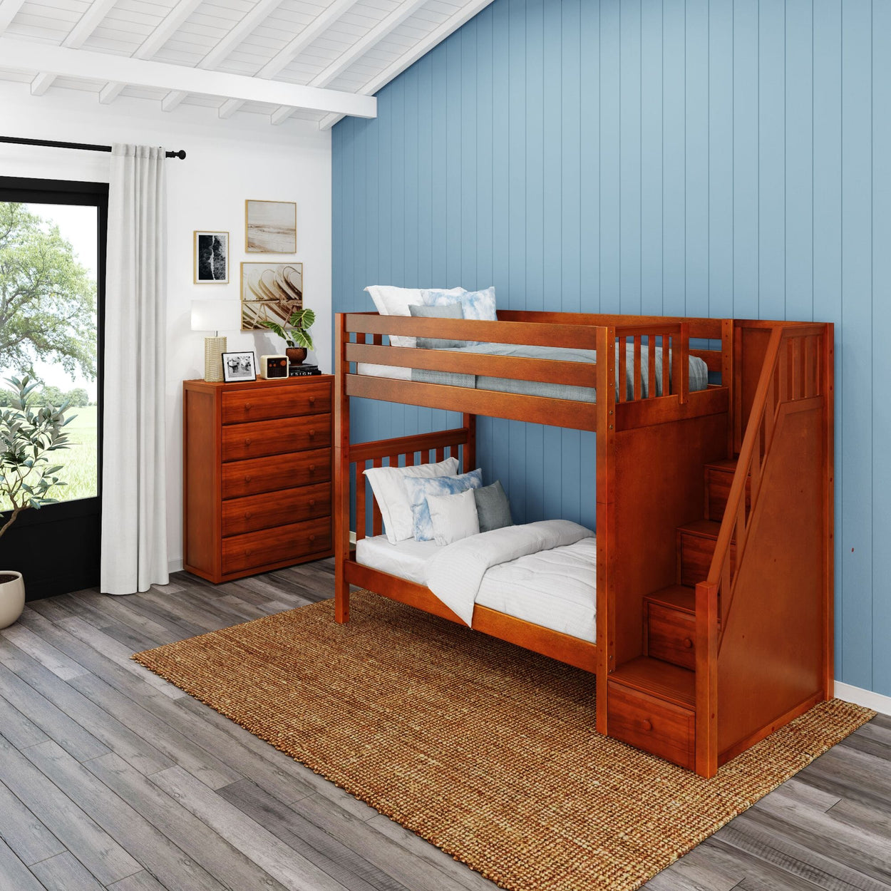 Wooden bunk bed with storage drawers in a modern children's bedroom with blue walls.