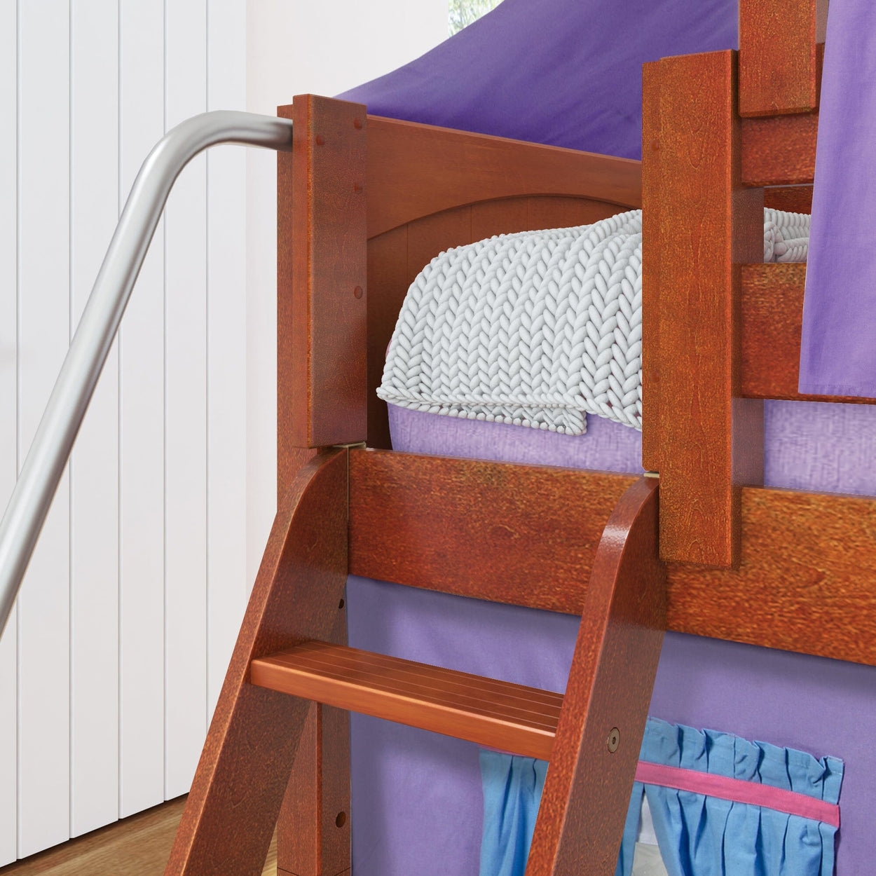 Wooden bunk bed with purple canopy and decorative pillow, ideal for kids' room decor.
