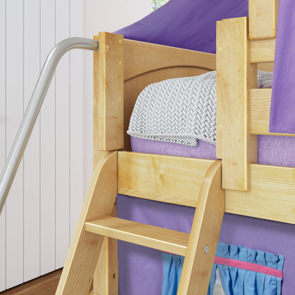 Wooden bunk bed with ladder and cozy blanket in a kids' room with purple accents.