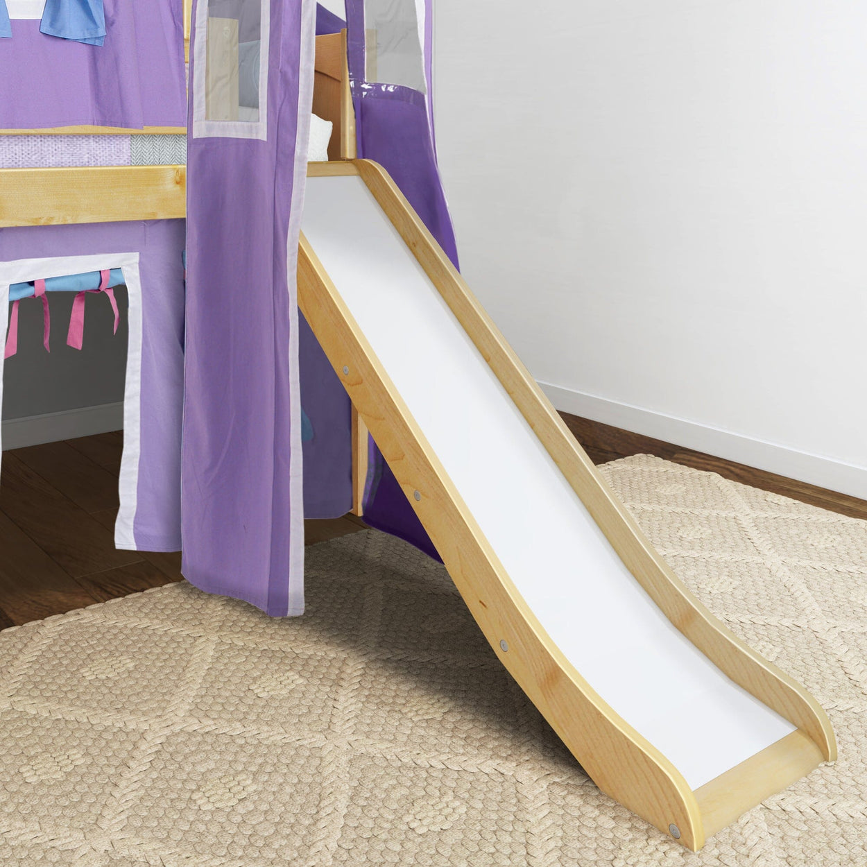 Kids' wooden loft bed with purple tent and slide on carpeted floor.
