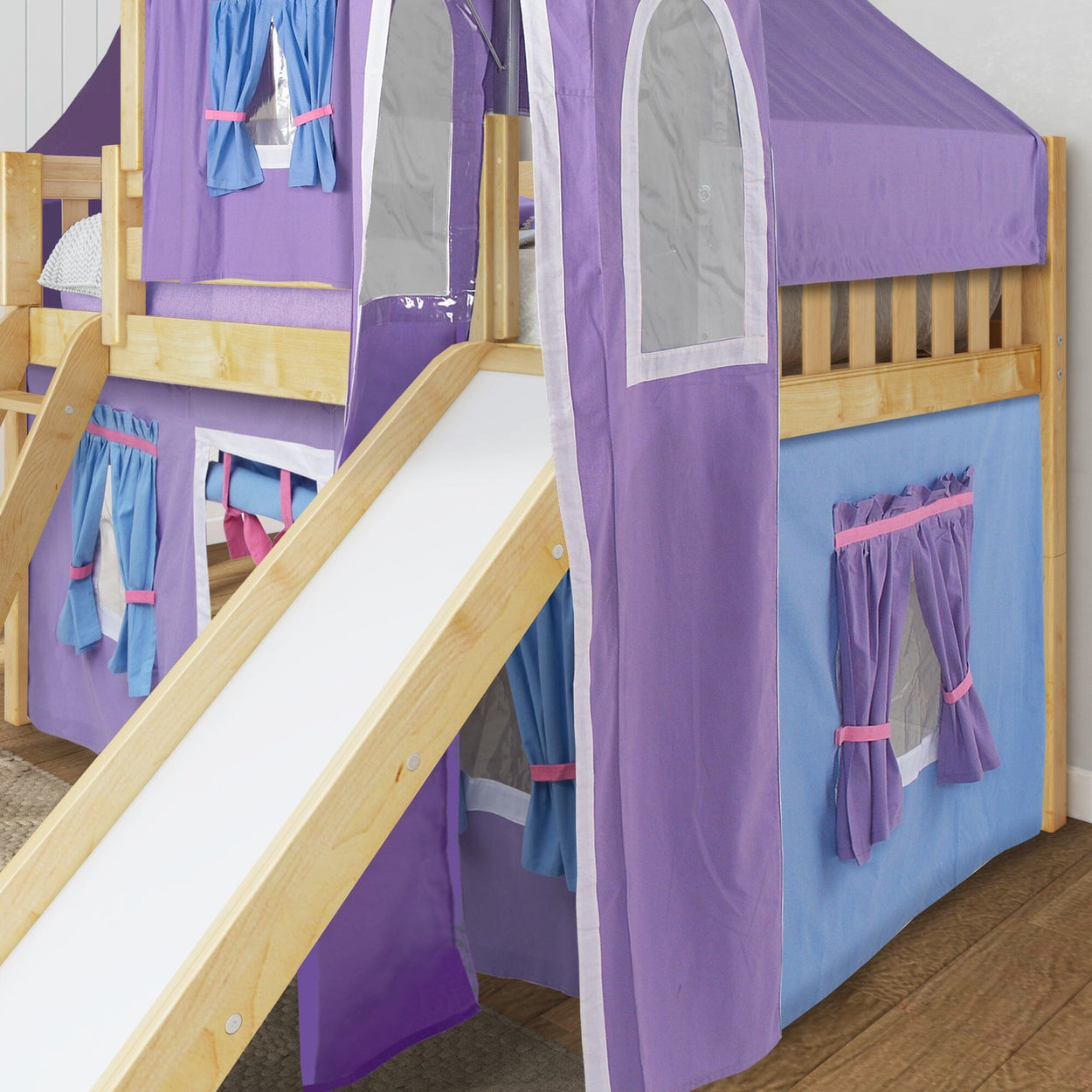 Purple and blue children's loft bed with slide and playful curtains.