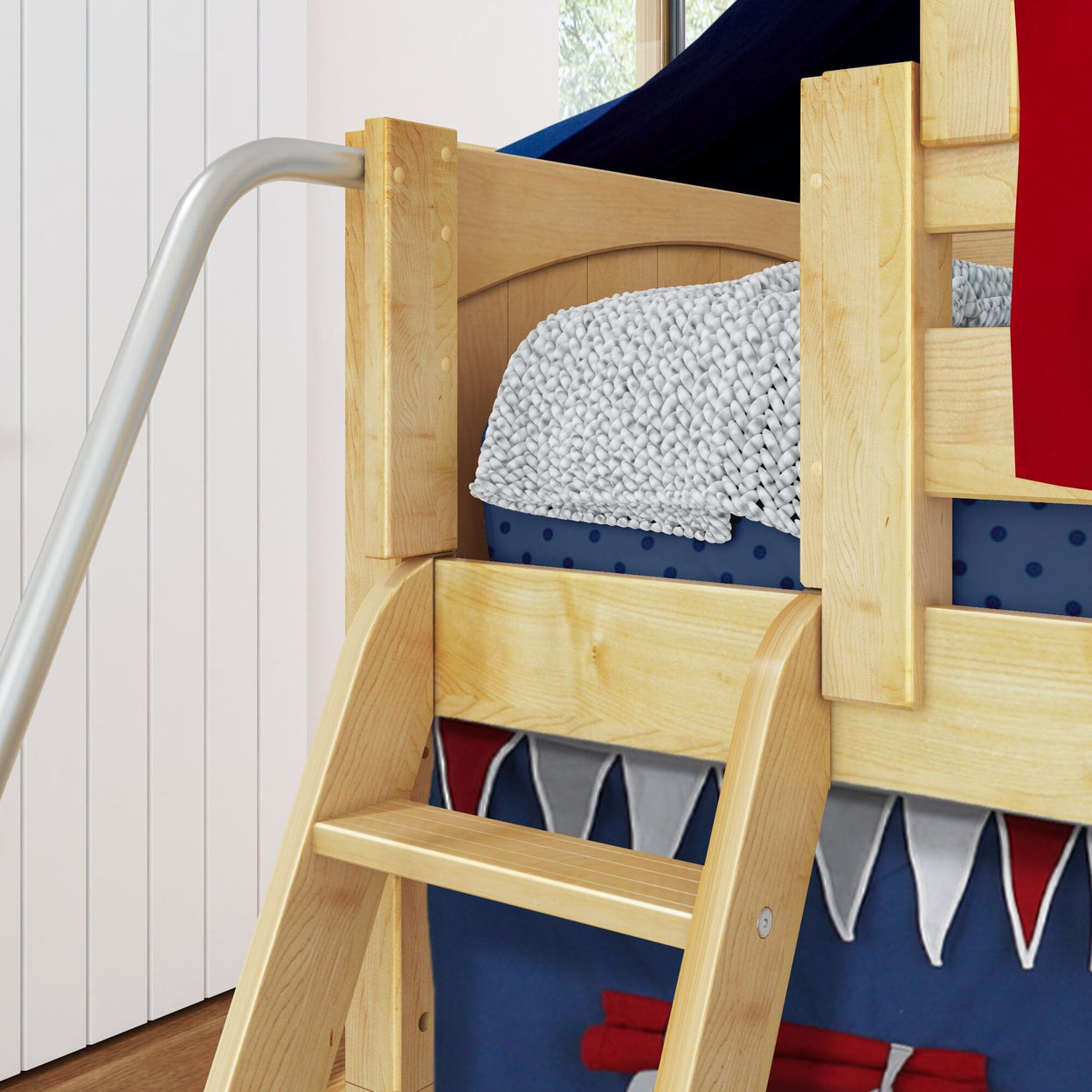 Wooden bunk bed with slide and ladder, decorated with cozy bedding and vibrant curtains, ideal for kids' bedrooms.