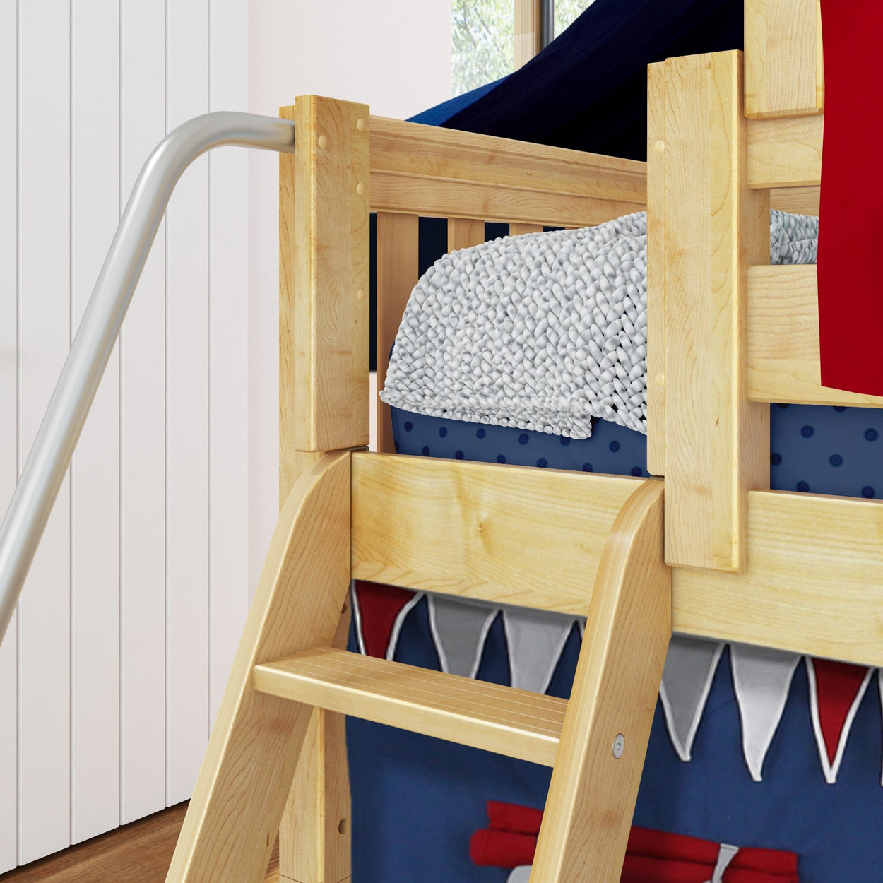 Children's wooden loft bed with slide and nautical-themed bedding for kids' room.