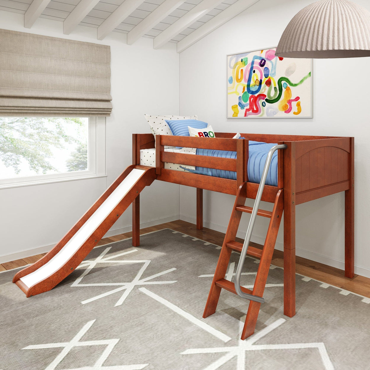 Children's loft bed with slide and ladder in a modern bedroom with colorful wall art and gray rug.