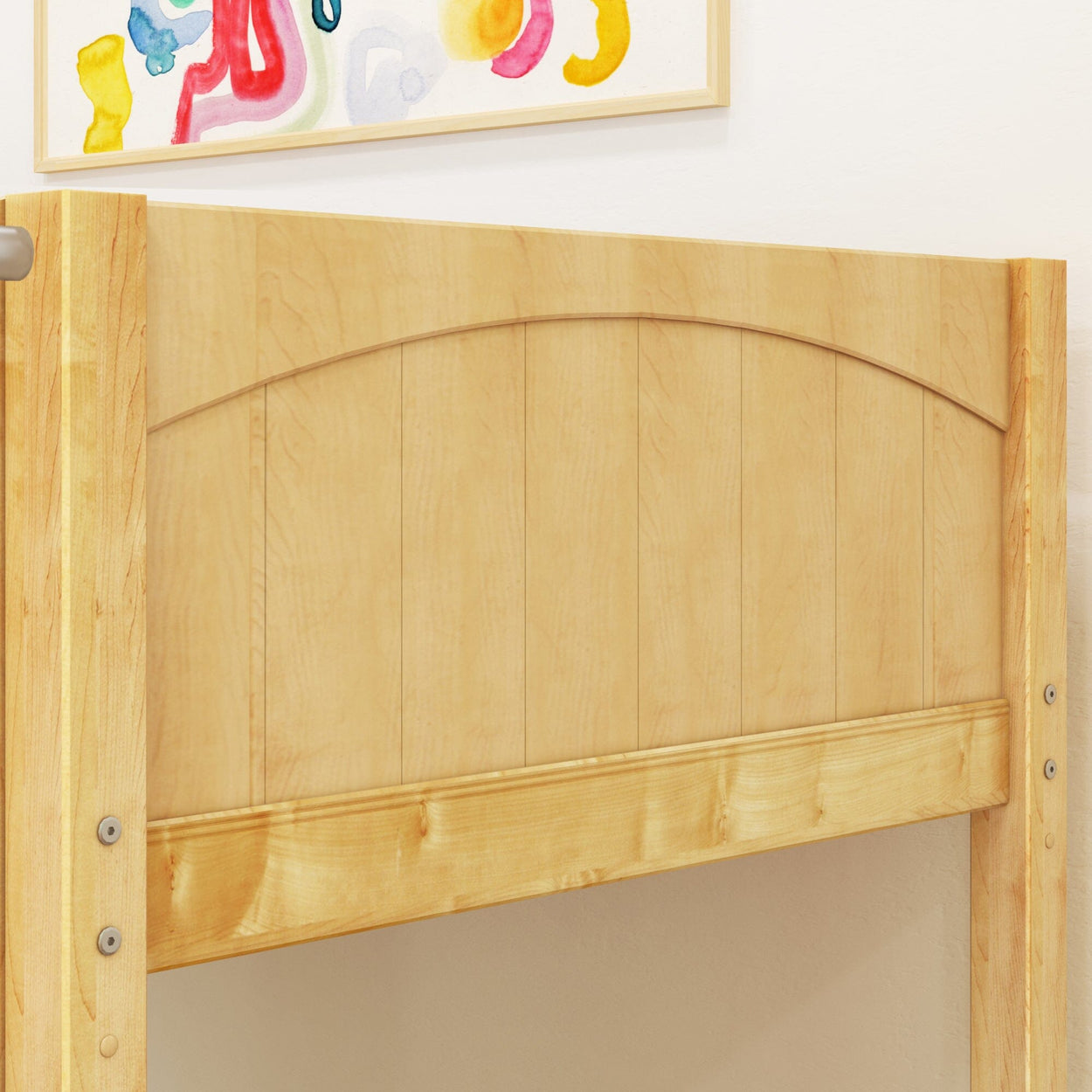 Wooden bed frame with light natural finish and colorful abstract wall art in the background.