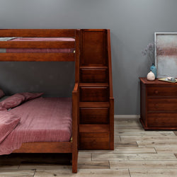 Wooden bunk bed with built-in stairs and drawers, next to a wooden dresser in a cozy bedroom setting.
