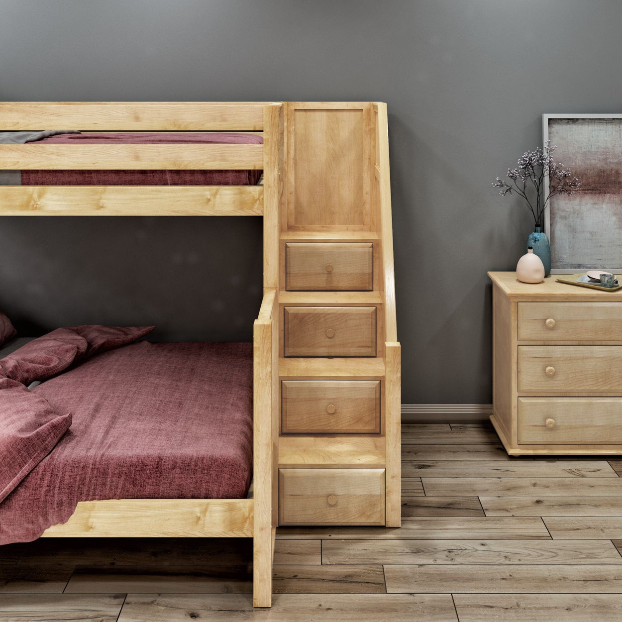 Wooden bunk bed with integrated storage drawers and pink bedding in a modern bedroom with dark gray walls and wooden flooring.