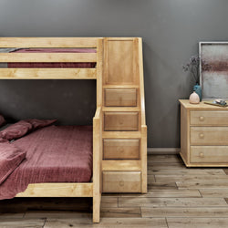 Wooden bunk bed with integrated storage drawers and pink bedding in a modern bedroom with dark gray walls and wooden flooring.