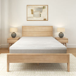 Modern minimalist bedroom with light wood furniture and abstract artwork.