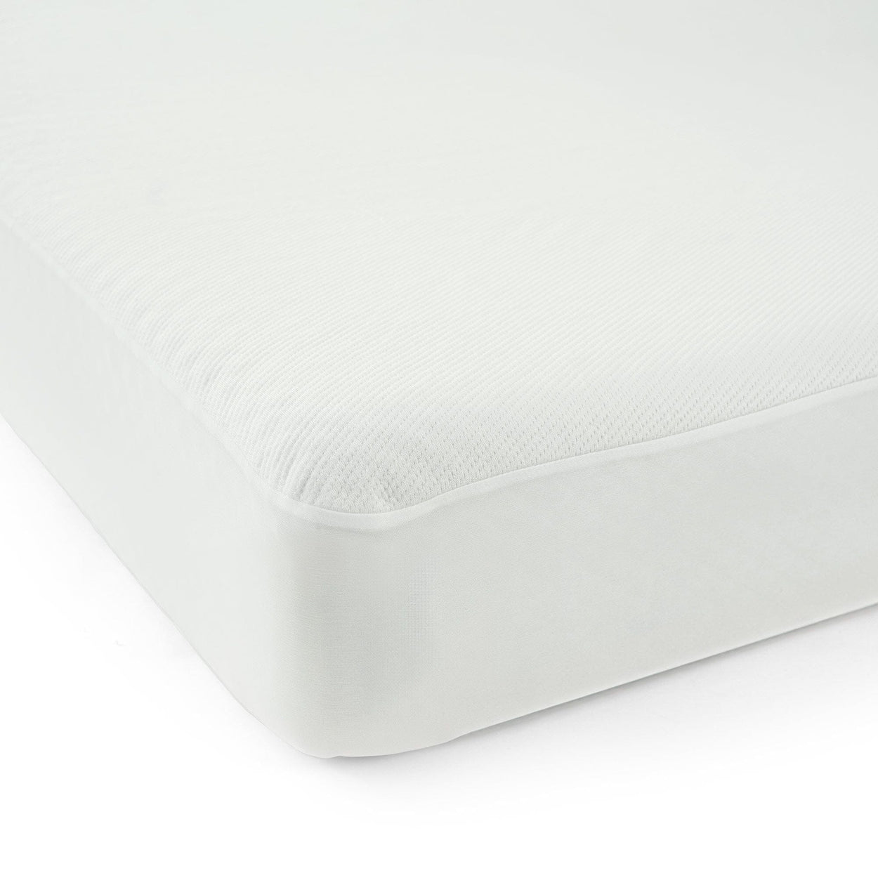 Plush white mattress corner close-up, highlighting high-quality bedding materials for a comfortable sleep.
