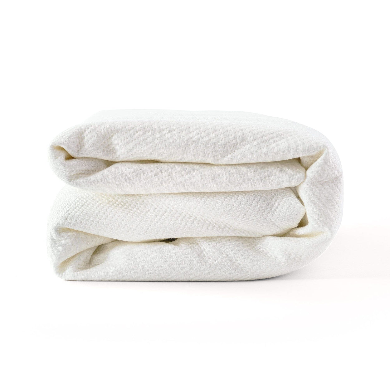 Folded white blanket made of breathable fabric for home bedding.