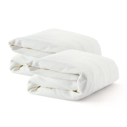 Folded white bed sheets set on a white background.