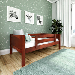 Child's bedroom with star-patterned wallpaper, wooden bed, and animal-themed wall art for a cozy and stylish kids' room design.