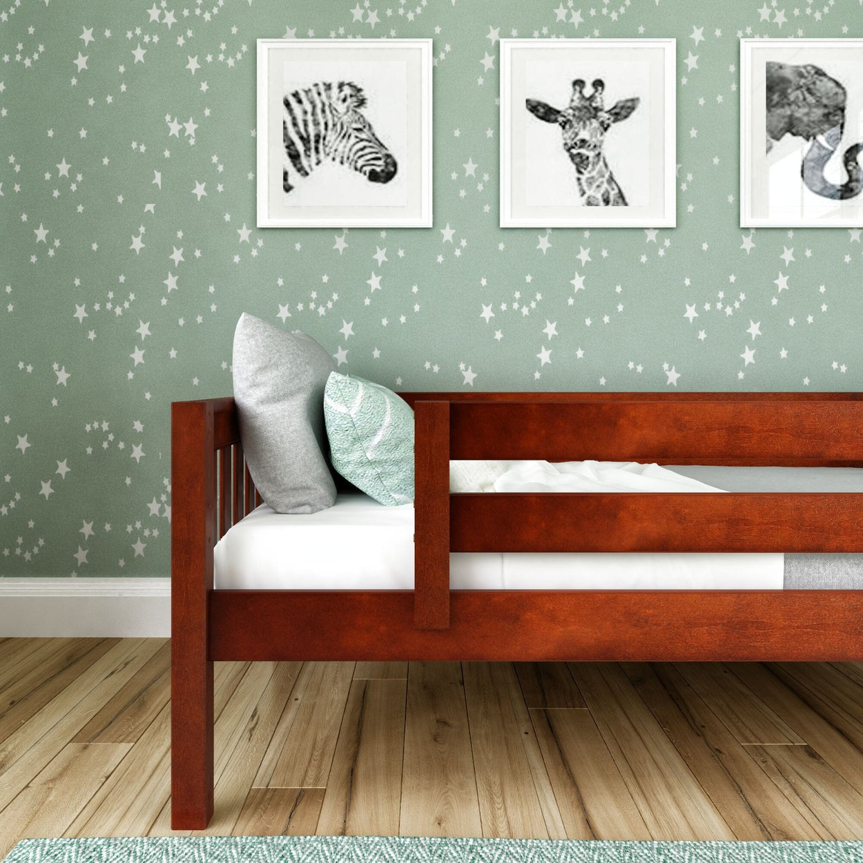 Toddler bed with wooden frame in star-themed nursery, featuring animal wall art, star wallpaper, and decorative pillows.