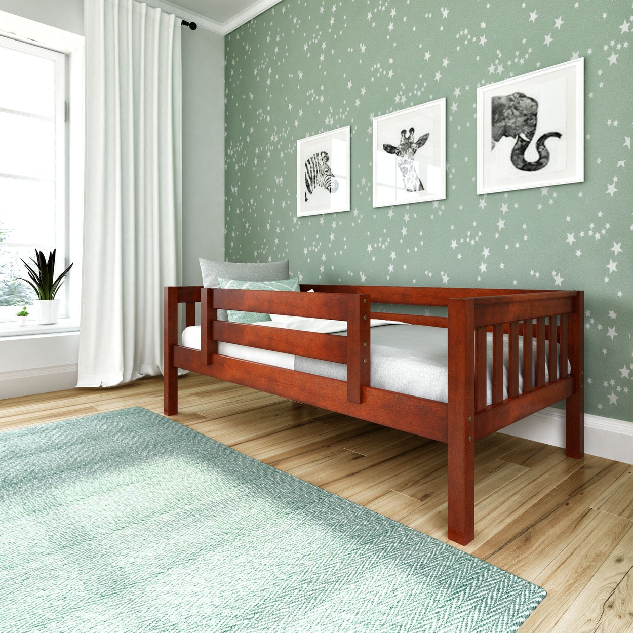 Wooden toddler bed in a nursery with green star-patterned wallpaper and animal prints.