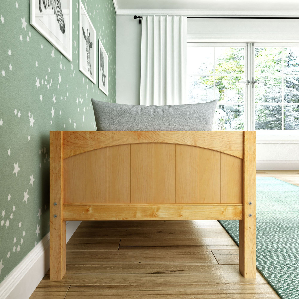 Wooden bed in a stylish kids' room with green star-patterned walls and animal artwork.
