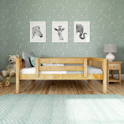 Kids' bedroom with wooden bed, animal wall art, star-patterned wallpaper, and stuffed bear.
