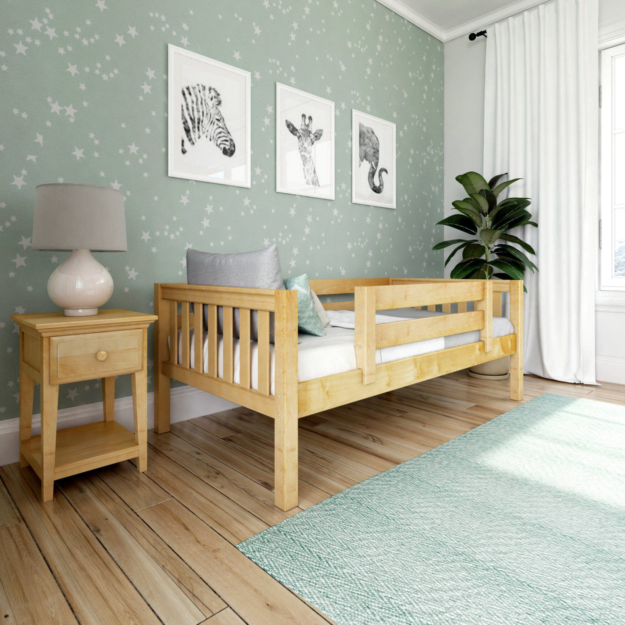 Children's bedroom with wooden toddler bed, green starry wallpaper, and framed animal art above the bed.