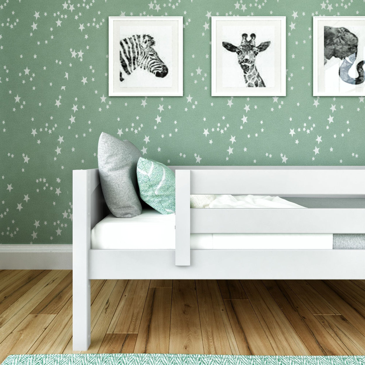 Children's room with a white bed, pastel green star-patterned wallpaper, and animal art prints.