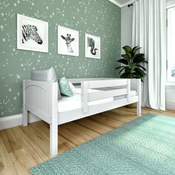 Children's bedroom with star-themed wallpaper, featuring a white bed, animal art, and green accents for a playful decor.