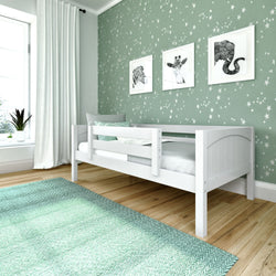 Stylish kids' bedroom with star-patterned wallpaper, white bed, and green rug.