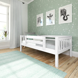 Child's bedroom with white single bed, star-patterned wallpaper, and animal wall art.