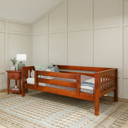 Wooden daybed with decorative pillows and a side table in a modern bedroom setting.