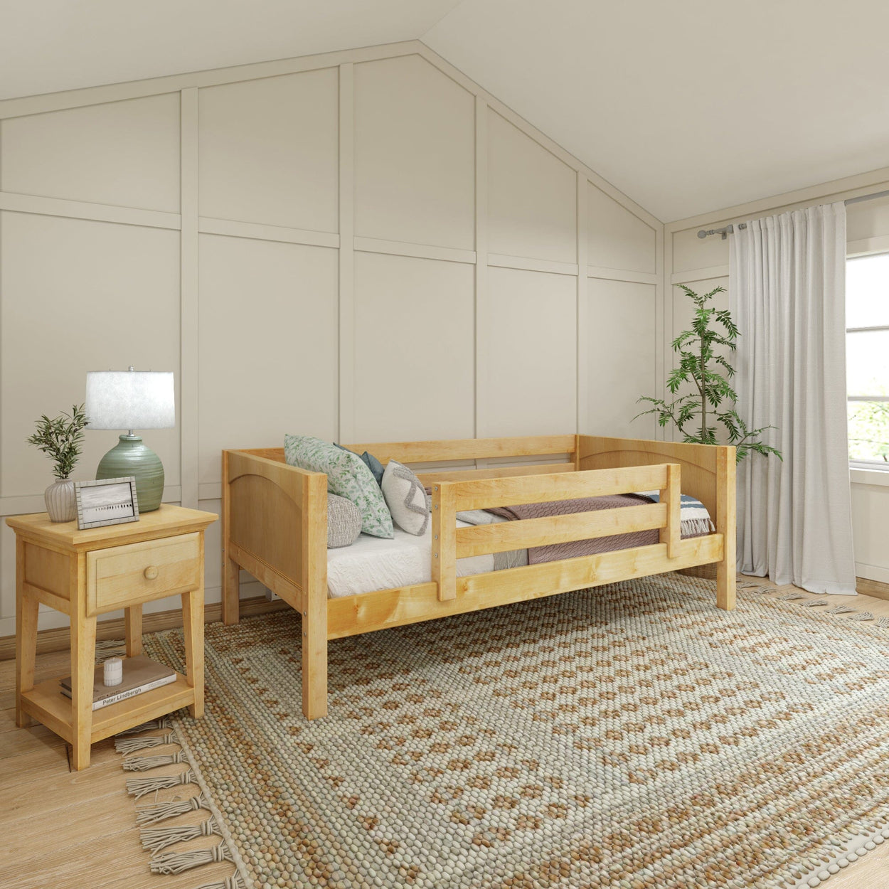 Cozy bedroom with wooden daybed, decorative pillows, nightstand with lamp, and woven area rug near large window.