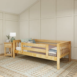 Wooden daybed with railings in a cozy bedroom, featuring a nightstand and decor elements, ideal for modern interior design.