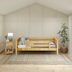Cozy minimalist bedroom with wooden bed, side table, lamp, and decorative plant on woven rug.