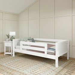 White daybed with throw pillows and a cozy blanket in a modern bedroom setting.
