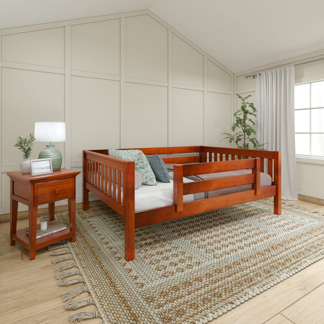 Cozy bedroom with wooden toddler bed, decorative pillows, bedside table, and woven rug.