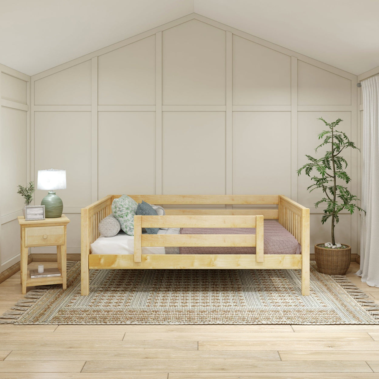 Cozy modern bedroom with wooden daybed, decorative pillows, side table, lamp, and indoor plant on woven rug.