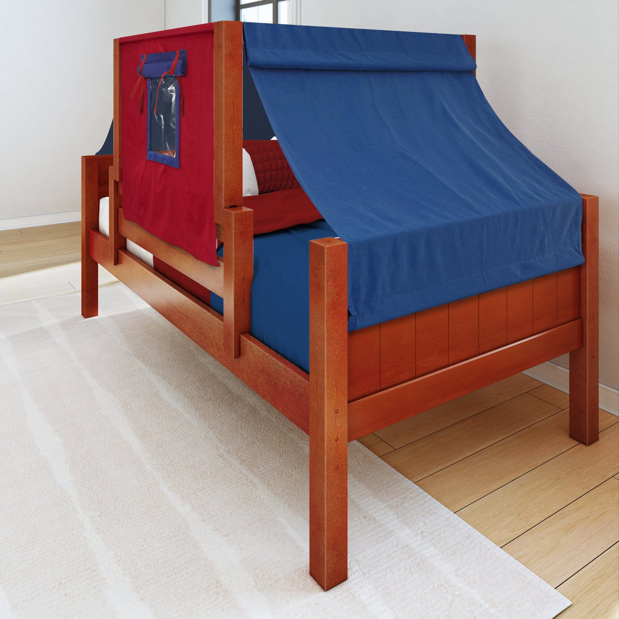 Red and blue children's tent bed with wooden frame on light wooden floor.