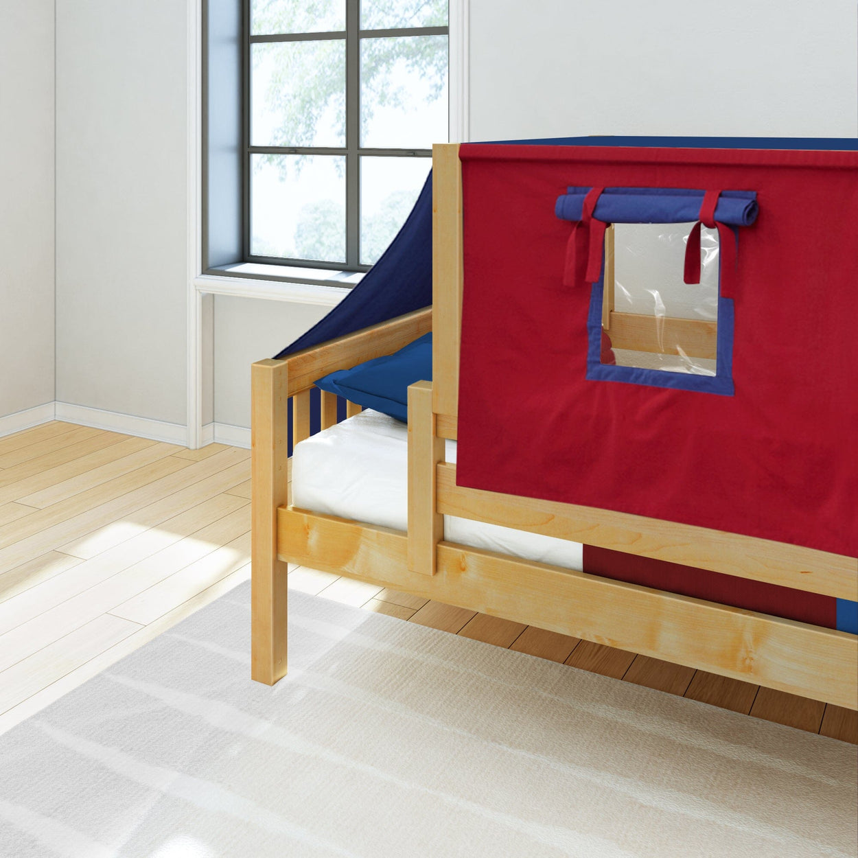 Children's wooden loft bed with red and navy blue play tent in a sunny room.