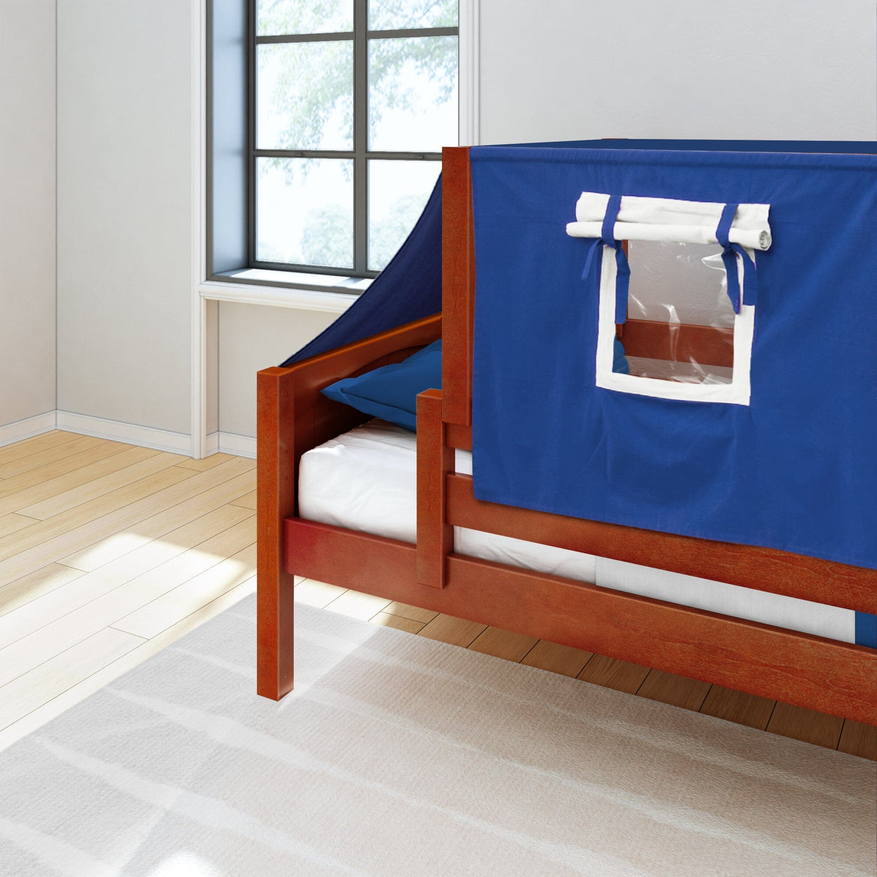 Wooden loft bed with blue tent cover and window in bright room.