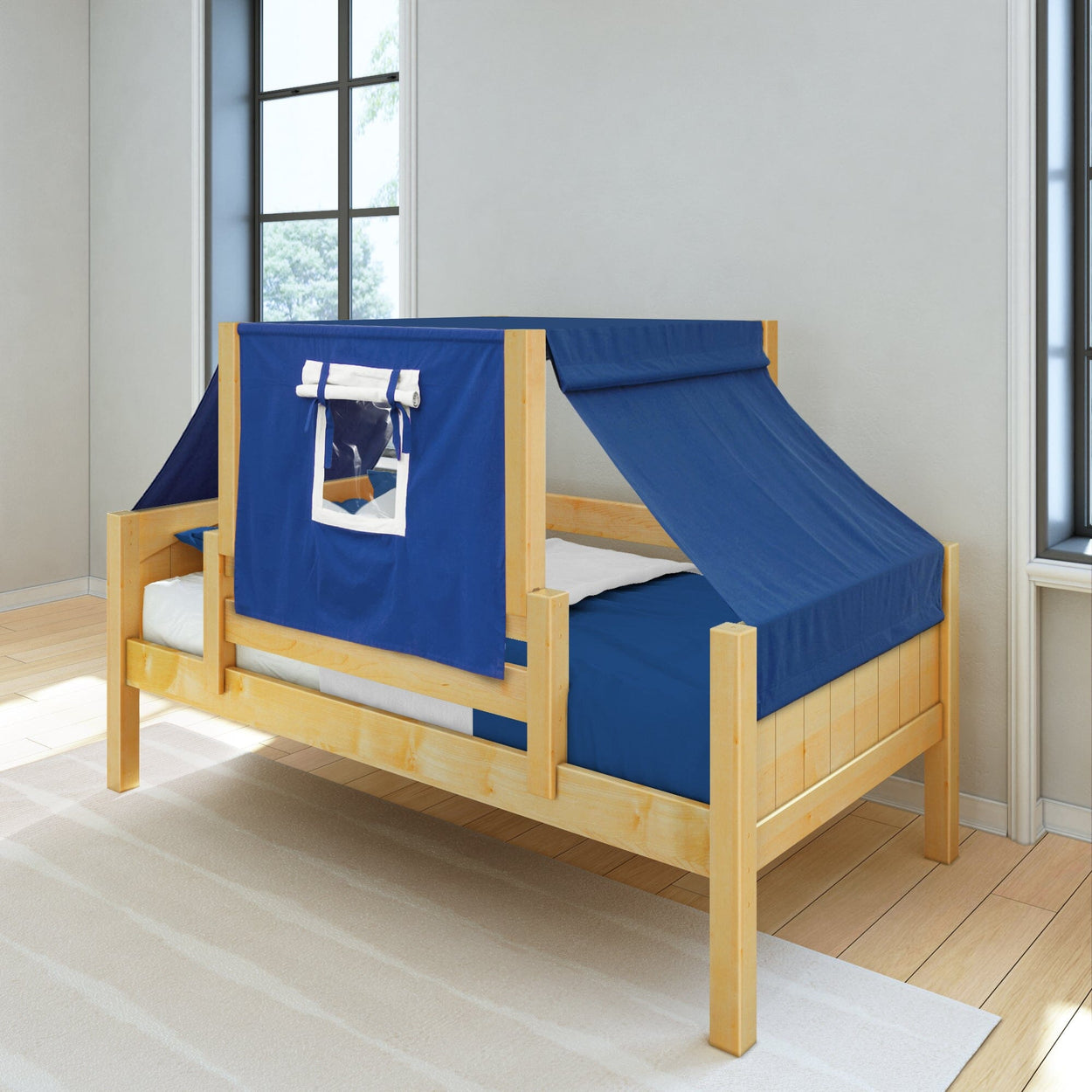Wooden child's bed with blue tent canopy in a bright bedroom.