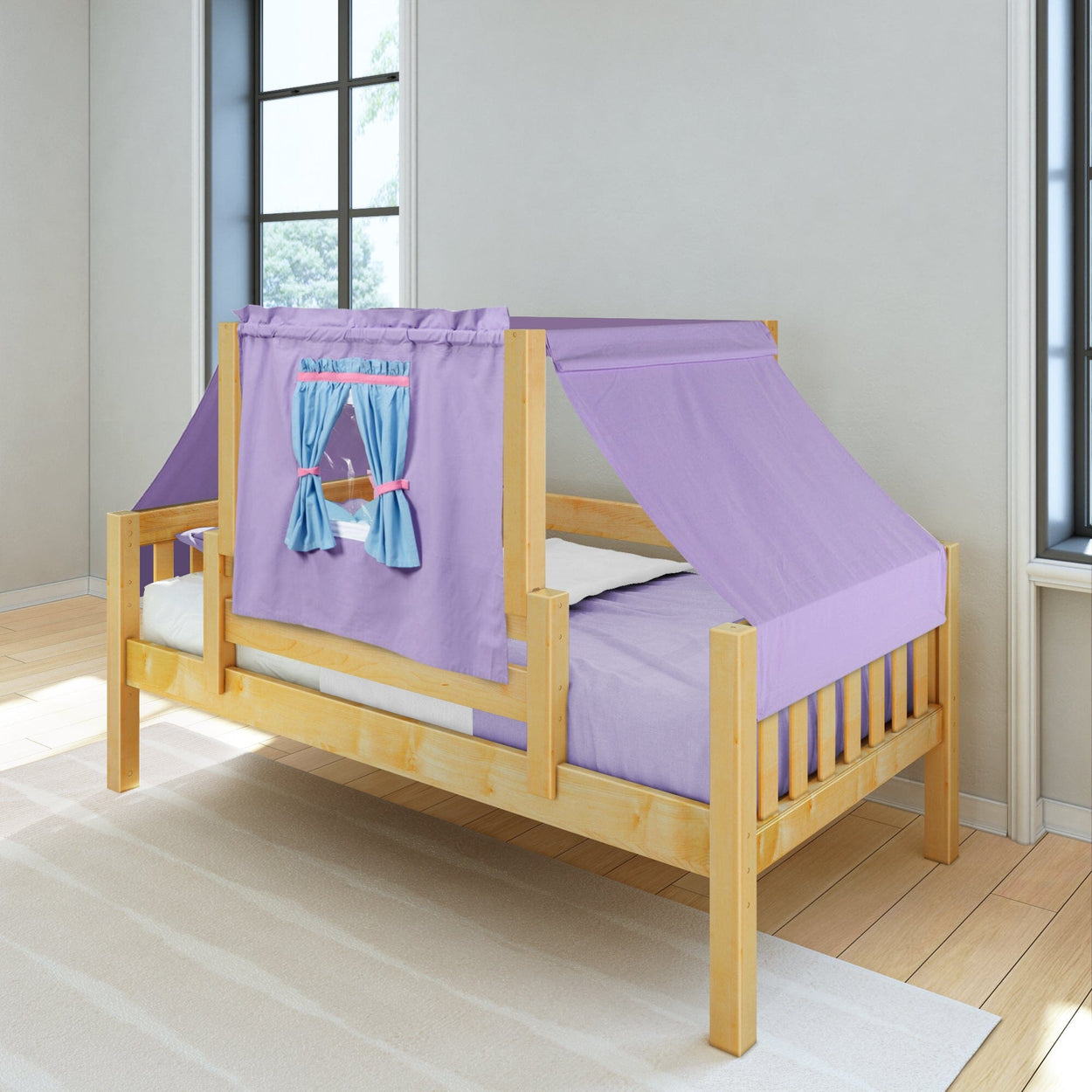 Children's wooden bed with purple tent canopy and blue window curtains in a bright bedroom.